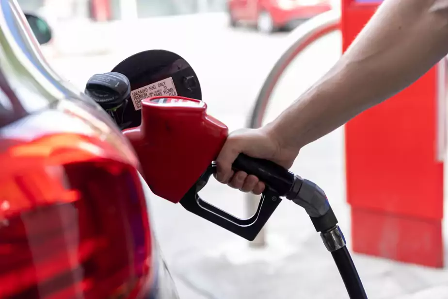 Un automobiliste met de l'essence dans une voiture